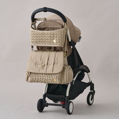 a baby stroller with an infant in it's seat and back pack attached to the side