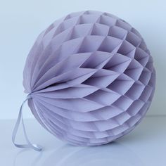 a purple paper ball sitting on top of a table