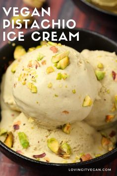 two scoops of pistachio ice cream in a black bowl