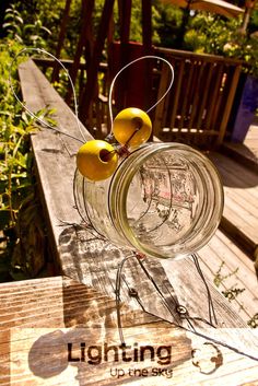 two lemons are sitting in a glass jar on a wooden table with the word lightning above it