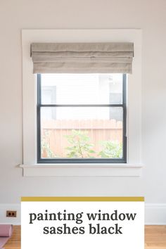 an empty room with wooden floors and a window in the corner that has blinds on it