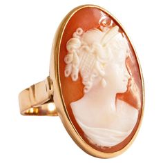 A vintage 14 K Yellow Gold ring with Cameo in an oval setting. The cameo features a female silhouette in the Victorian style. The ring is stamped with K14 that stands for the 14 karat gold content. The item was manufactured in the middle of the 20th century and it is in good vintage condition. The ring size is 6.5. The Cameo ring is one of the most classic example of jewelry that is indispensable in each woman's collection. Cameo Rings Vintage, Female Silhouette, Oval Setting, Cameo Ring, Carved Shell, Woman Silhouette, Yellow Gold Ring, Victorian Style, Yellow Gold Rings