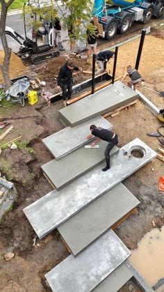 two men are working on some concrete steps