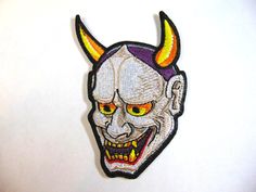 Japanese Hannya Oni Kabuki Noh Mask (Demon Samurai Assassin)  This is an Iron-on patch measuring approximately  10" (Height). We design and manufacture a variety of embroidered designs for all occasions. We use high-quality materials such as Isacord thread and our materials are sourced from responsible and environmentally conscious companies. We offer retail and wholesale custom orders with no minimum order quantity. Simply send us your design with size, color, and quantity specifications and we will respond within 24 hours with a price quote. Samurai Assassin, Demon Samurai, Noh Mask, Embroidered Designs, Environmentally Conscious, Embroidered Design, Custom Orders, Sell On Etsy, Etsy Accessories