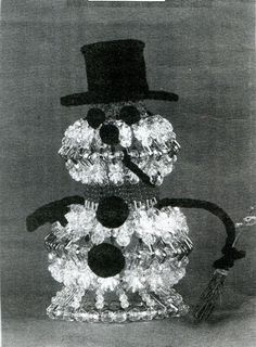 a snowman made out of crystal stones with a top hat on it's head