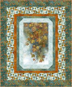 a quilt with leaves on it in the center and an orange border at the bottom