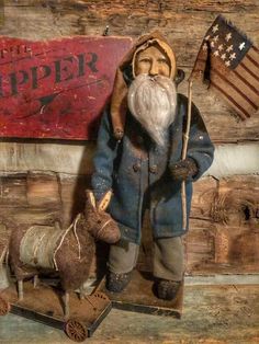 an old man with a beard and long white hair is standing in front of a wooden sign