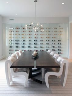 a dining room table surrounded by white chairs