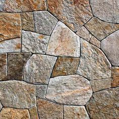 a stone wall that has been made from different types of stones and is very attractive to look at