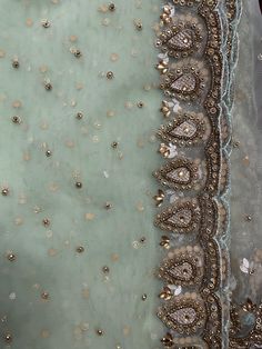 an embroidered fabric with beads and sequins