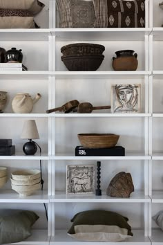 the shelves are filled with decorative items and baskets