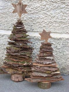 a wooden christmas tree made out of logs