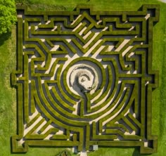 an aerial view of a maze in the grass