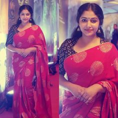 a woman in a red sari posing for the camera