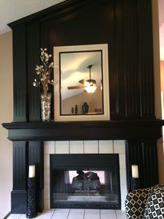 a living room with a fire place and a mirror above the mantel on top of it