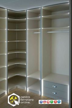 an empty walk - in closet with shelves and drawers on each side, illuminated by lights