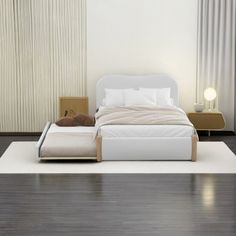 a white bed sitting on top of a wooden floor