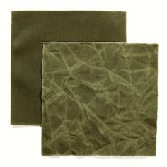 two pieces of green fabric sitting on top of each other