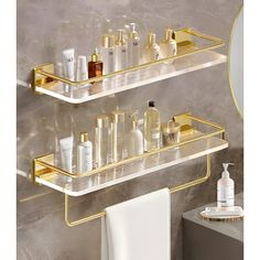 two gold shelves with bottles and soaps on them