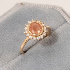 "Floral Oregon Sunstone Ring/Sunstone Diamond Halo Ring/Sunstone Engagement Ring for Her/14K Solid Gold/Natural Sunstone Jewelry/Handmade ★ ★ ★ ★  CUSTOM/DUTY-FREE SHIPPING WORLDWIDE, BUYERS DON'T HAVE TO PAY ANY CUSTOM FEES WHILE IMPORTING ★ ★ ★ ★  Details Made to order Material: 14k/18k gold Color Options: Yellow Gold, White Gold, Rose Gold ★ Center Stone Oregon Sunstone Round Size: 6 mm  Approx Weight (Ct): 1.03 ★ Accent Stones Diamond/Moissanite Round Size: 1.5 mm * 16 Nos.  Approx Weight (C Sunrise Engagement Ring, Sunset Engagement Ring, Sun Diamond Ring, Sun Stone Ring, Oregon Sunstone Engagement Ring, Engagement Rings Boho, Sunburst Engagement Ring, Orange Engagement Ring, Amber Engagement Ring