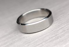 a wedding ring sitting on top of a wooden table