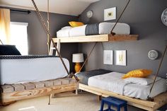 a bedroom with bunk beds and swings in it