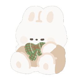 a white teddy bear with a green scarf around its neck