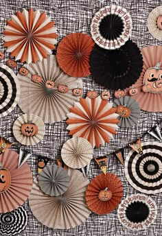 an assortment of paper fans with pumpkin faces on them