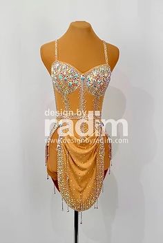 a mannequin wearing a gold dress with beadings and beads on it