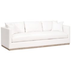 a white couch sitting on top of a wooden table