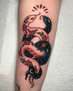 a snake with flowers and stars on it's arm is shown in this tattoo design