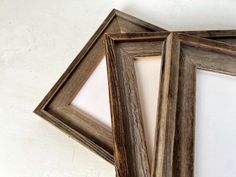 three wooden frames sitting next to each other