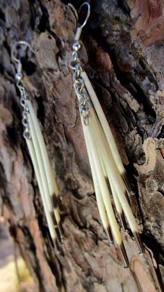 Porcupine quill chain dangle earrings that cascade from ear and beautifully displays mother's natures bounties. 100% Natural. Length: 3 1/2 Inches; Width: 1/2 Inches These quills were ethically sourced from a vehicle hit porcupine. No porcupines were injured or harmed on our behalf. We provided a proper burial for him. All quills are given a bath in a natural cleaning sloution. Due to utilizing Mother Earths gifts, every piece will uniquely differentiate from the next. We capture each piece as it is found in nature, unadultered. Some pieces may display imperfections which add to the natural character of each individual piece. DISCLAIMER: I am not a member of any state or federally recognized tribes nor do I or have I ever claimed to be. This shop and our crafts are inspired by my Tsalagi(C Porcupine Jewelry, Porcupine Quill Jewelry, Quill Jewelry, Quill Earrings, Quill Work, Earth Gift, Porcupine Quills, Sci Fi Fashion, House Items