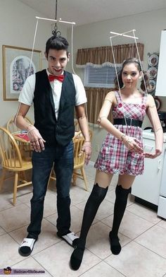 a man and woman dressed up as marion swingers in a living room with white tile flooring