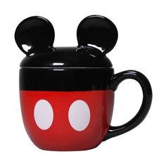 a black and red mickey mouse mug with two white circles on it's face