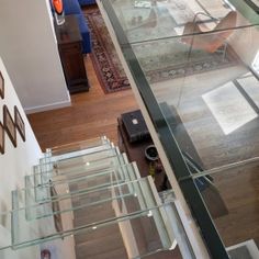 an aerial view of a living room with stairs leading up to the second floor, and a blue couch in the background