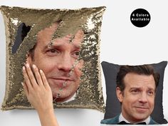 a pillow with a photo of a man's face on it next to a cushion