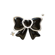 a black and white bow brooch with pearls