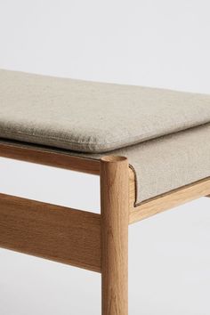 a close up of a bench cushion on top of a wooden frame with a white background