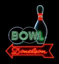 a neon sign that says bowling and a bowling ball