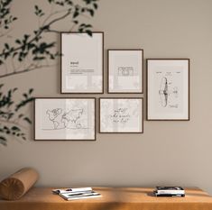 four framed photographs hang on the wall above a table