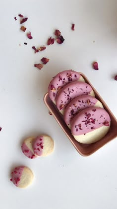 some cookies with pink frosting and sprinkles