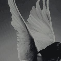 a black and white photo of a woman with wings