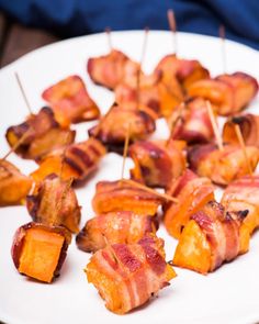 bacon and pineapple skewers on a white plate