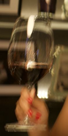 a person holding a wine glass in their hand