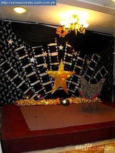 the stage is decorated with gold stars and ribbons