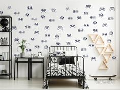 a bedroom with black and white wallpaper that has cars on it