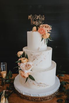 a white wedding cake with flowers on top