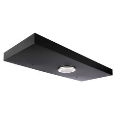 a black square light fixture on a white wall