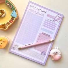 a daily planner next to some toys on a table